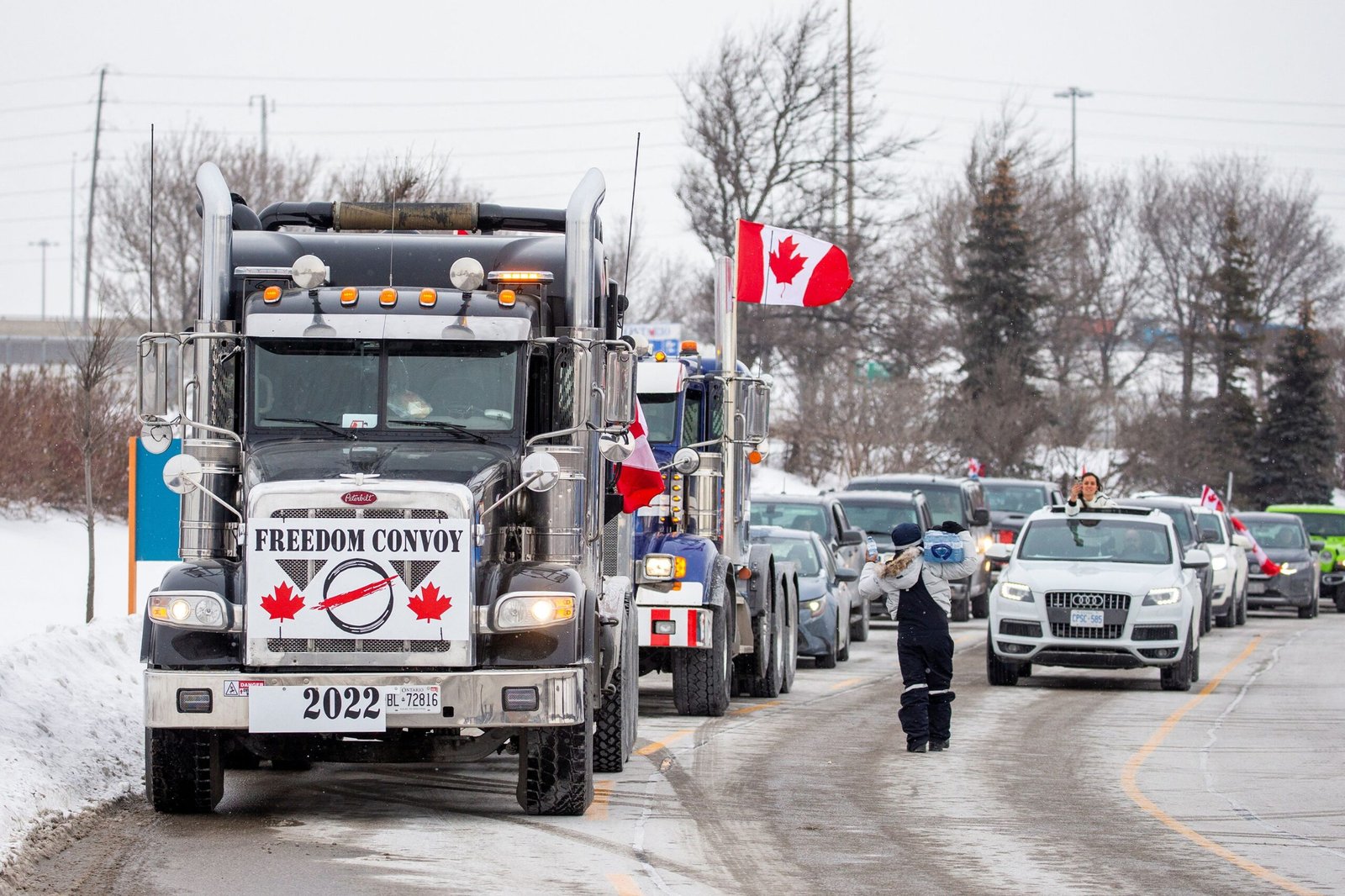 Truckers drive through Toronto on their way to Ottawa to protest COVID-19 vaccine mandate