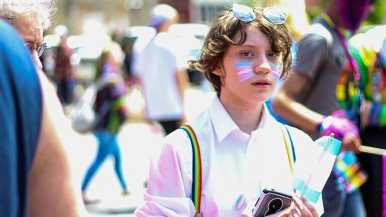 boy-holding-smartphone-and-flaglet-e1650571625599-1200x675