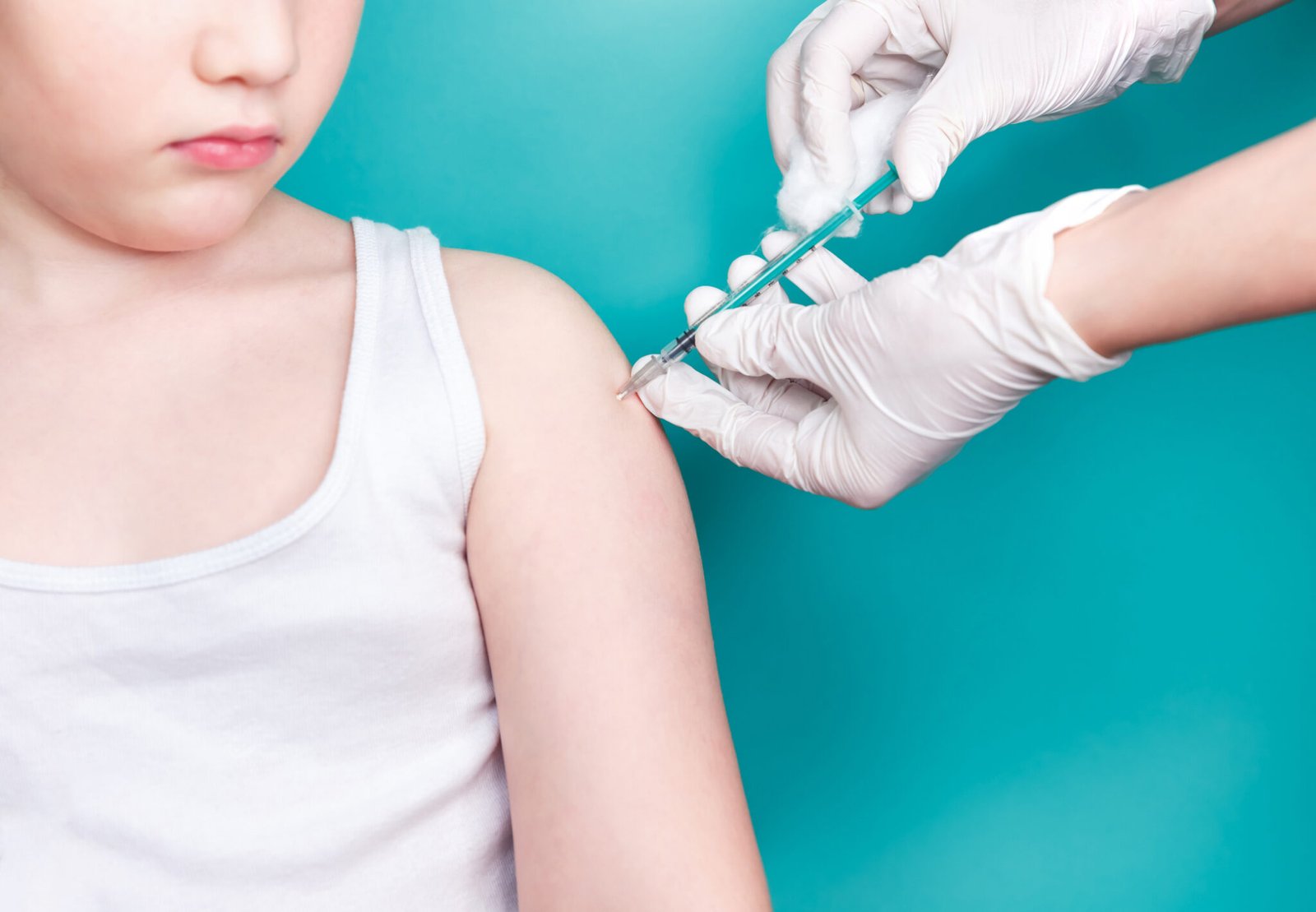Doctor makes vaccination to a child. Inoculation in the shoulder